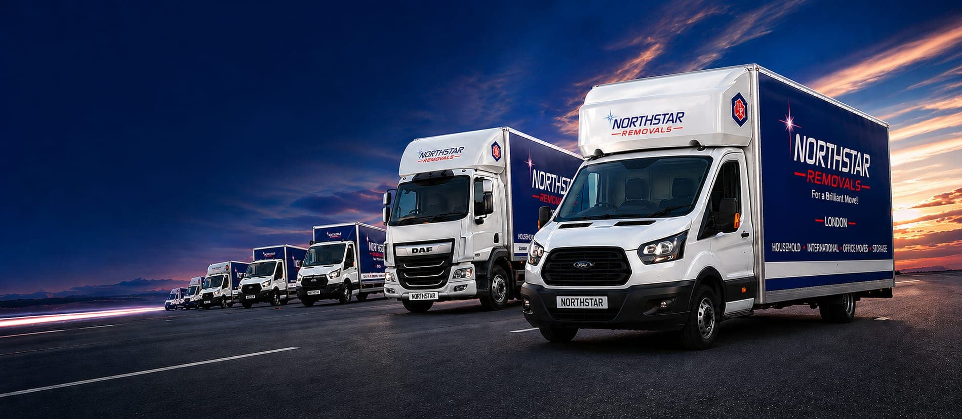 The Northstar Removals fleet of branded trucks at dusk
